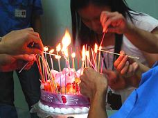 Chinese workers lighting a birthday cake for Michael Hammers